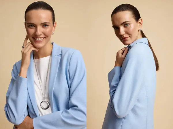 Kobieta w błękitnej marynarce i białej koszulce prezentuje stylowy total look. Długi naszyjnik i subtelna biżuteria dopełniają całość.
